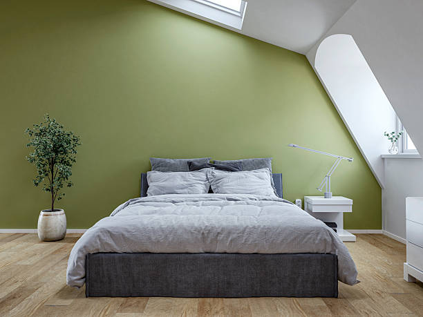 Bedroom with sage green accent wall and crisp white trim by a painting company in La Jolla, CA.