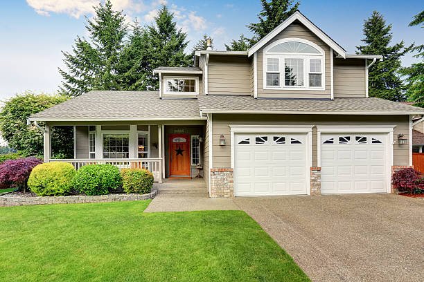 Warm beige exterior paint with crisp white trim and garage door finishes by a house painter in San Diego, CA