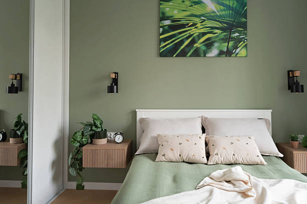 Bedroom with sage green walls and crisp white trim by an interior painter in Carlsbad, CA.