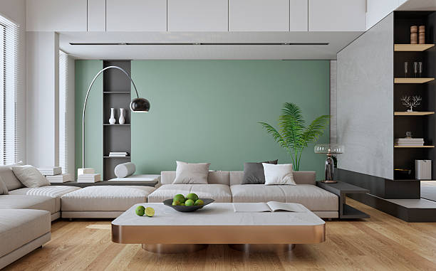 Living room with a soft green wall, white trim, and complementary paint finishes by an interior painter in Del Mar, CA